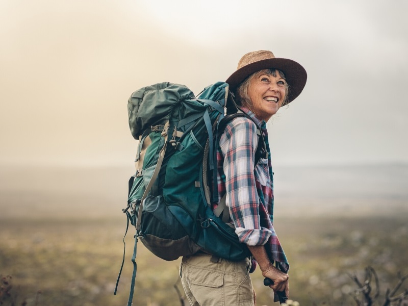 Woman hiking and traveling in retirement