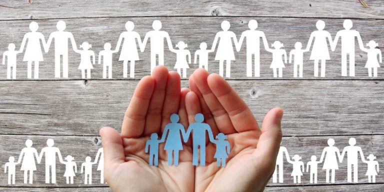 Family dimension of wealth - graphic of hands holding paper cutout of family members
