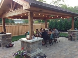 A photo of Jorie's patio in her backyard with several friends sitting around a table.
