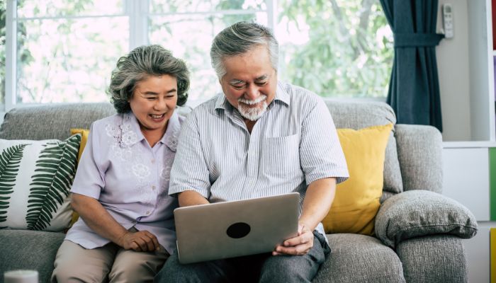 older couple on couch with ipad