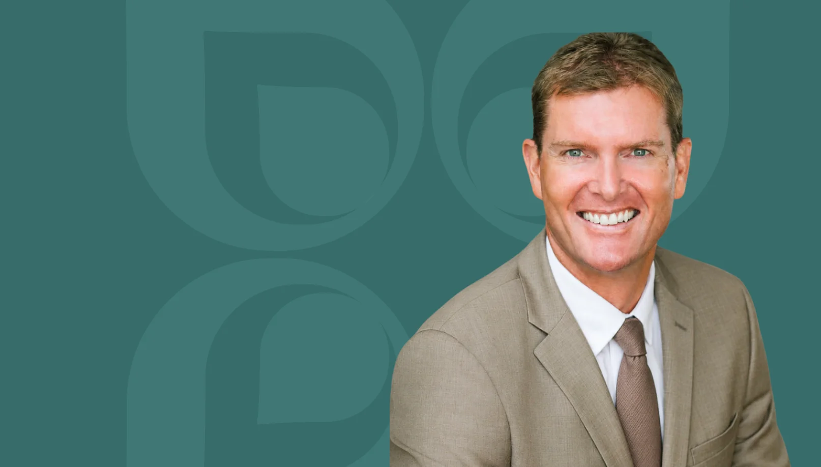 Smiling professional in a suit against a teal background, emphasizing investment cost management expertise.