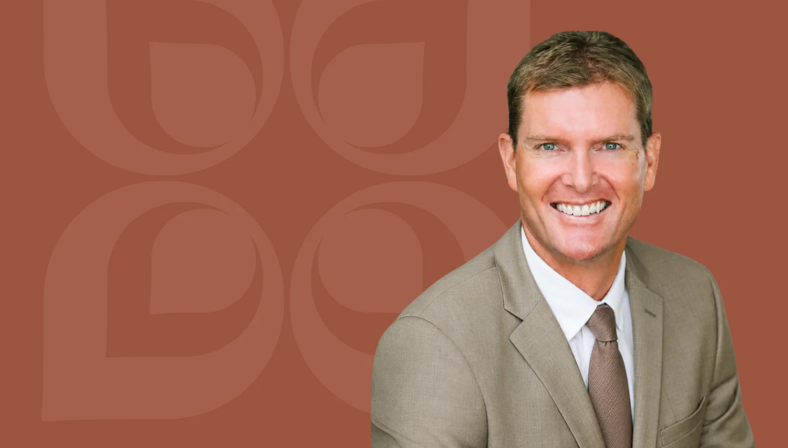 Smiling professional in a suit, representing expertise in financial asset location strategies and benefits.