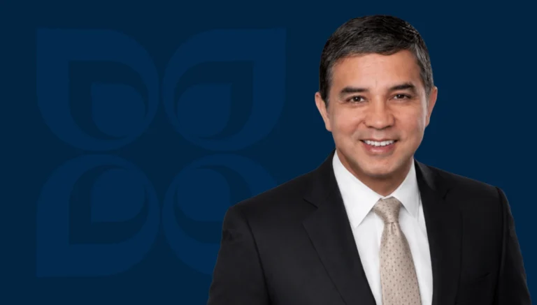 Rick D. Gonzalez smiles confidently in a suit, representing success in mergers and acquisitions at Mission Wealth.