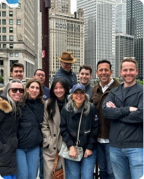 Jeff Avila Mission Wealth team poses together in a city setting, showcasing camaraderie and professionalism.