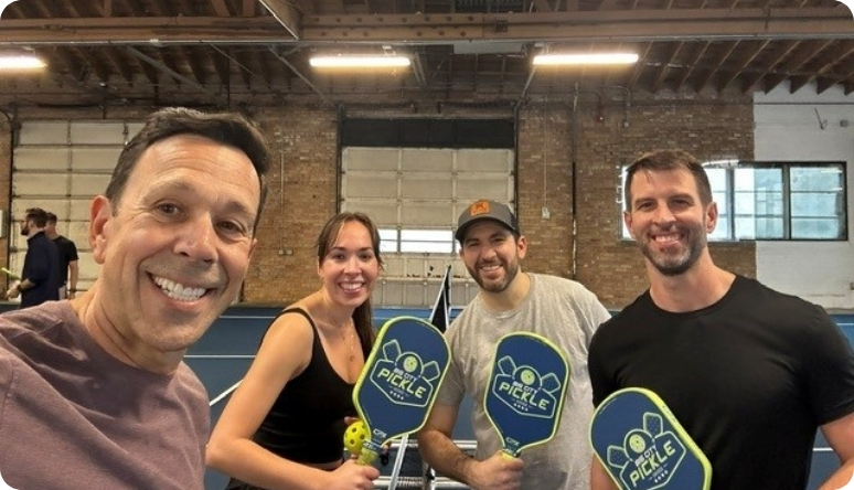 Jeff Avila Mission Wealth team enjoys a fun pickleball game, showcasing teamwork and camaraderie in a vibrant setting.