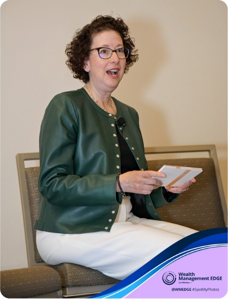 Joyce L. Franklin engages the audience while speaking at a Wealth Management EDGE event, holding notes in her hand.