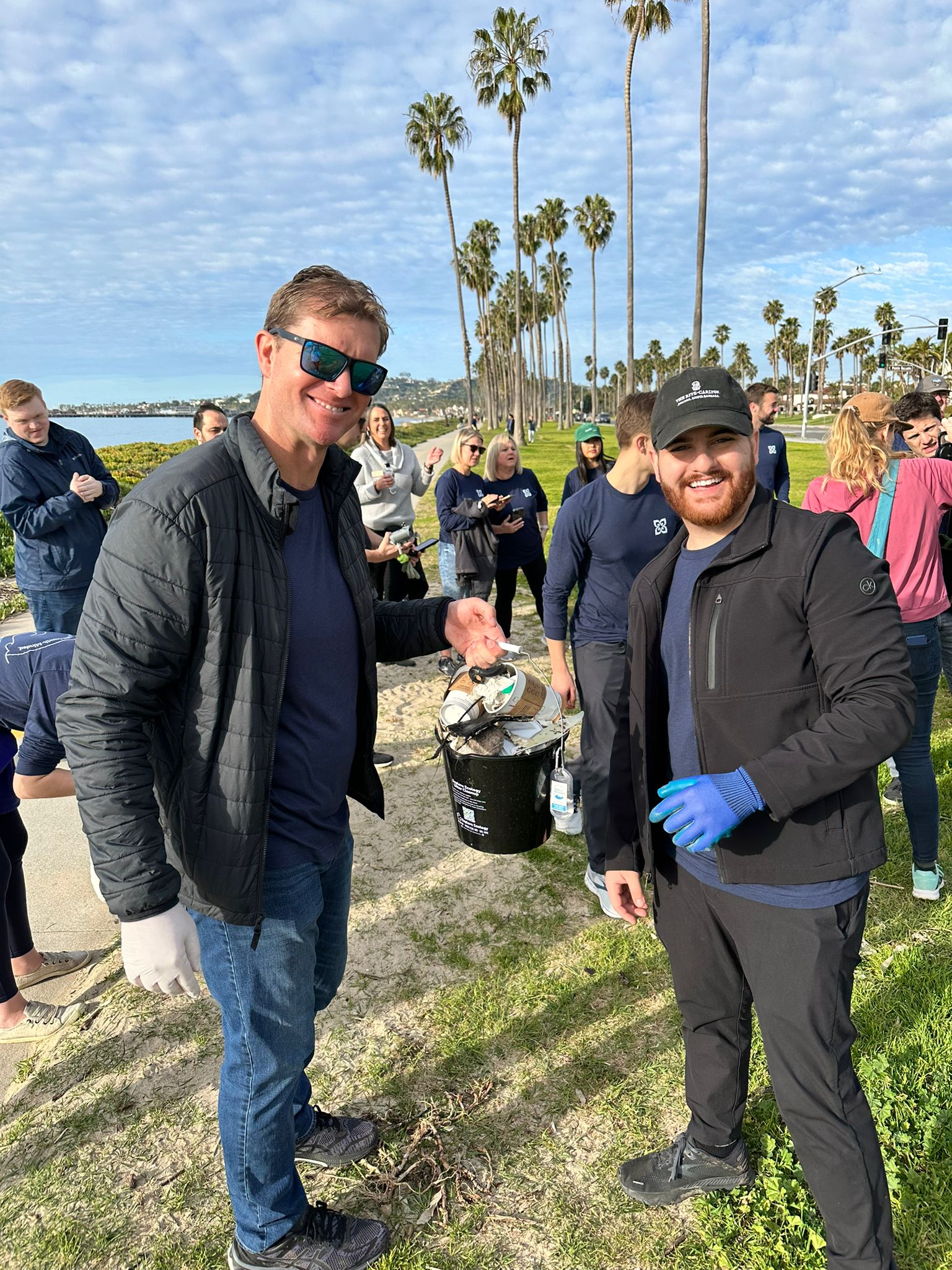Kieran Osborne collects litter with a colleague during a Mission Wealth community cleanup.