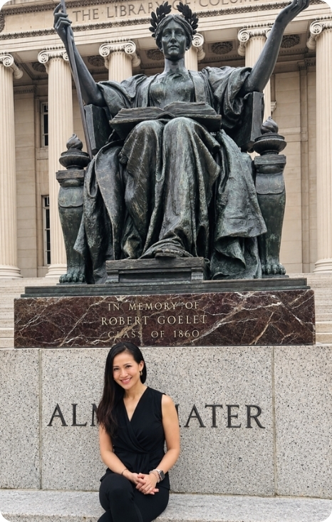 Leah Naish poses in front of a statue commemorating Robert Goelet at the Library of Columbia University.