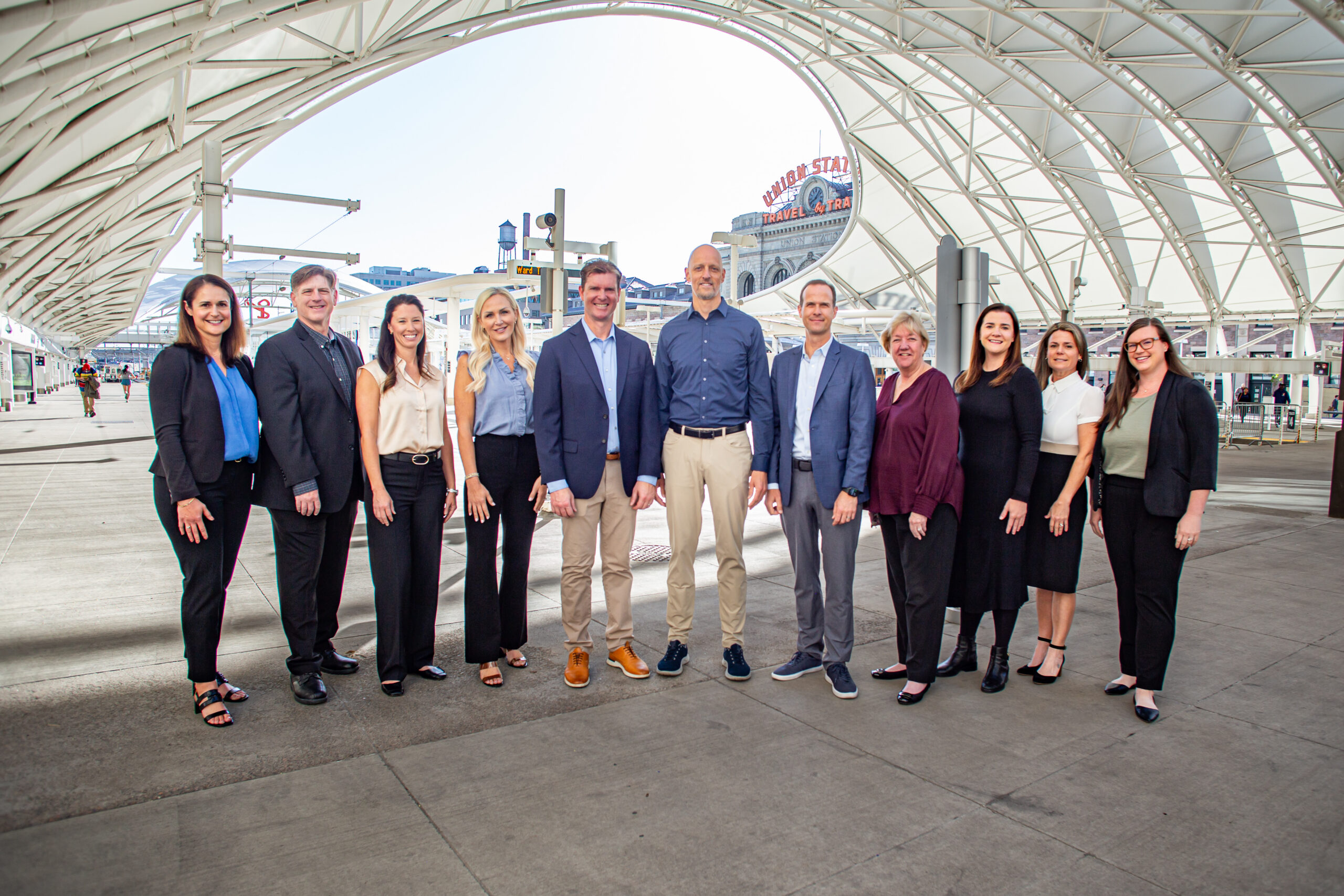 Matt Adams stands with the Mission Wealth leadership team near Denver Union Station.
