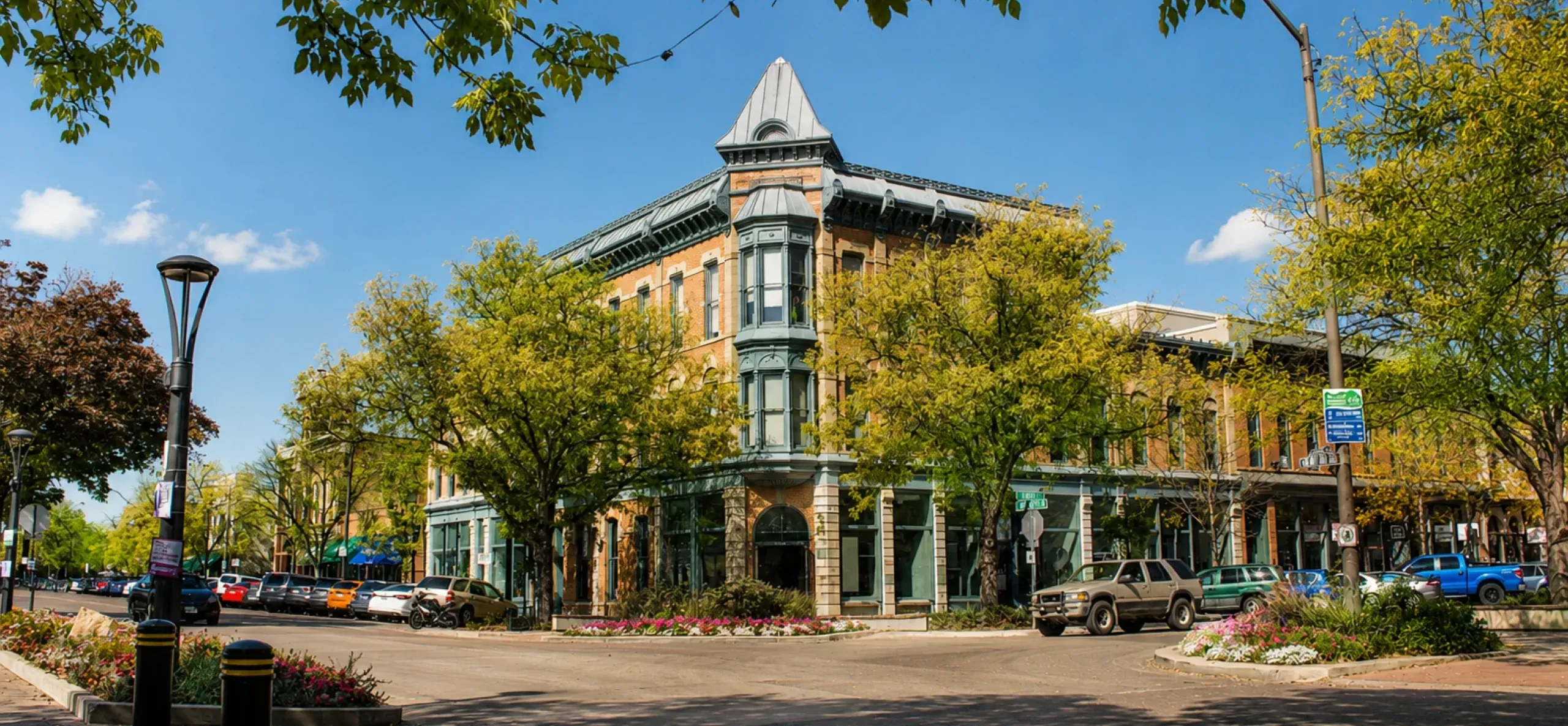 Historic building surrounded by trees and flowers in Fort Collins, ideal for finding financial advisors near me.