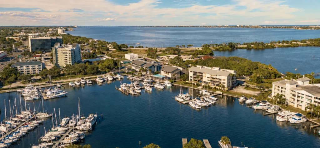 Aerial view of Melbourne's marina with boats docked, residential buildings, and a scenic waterfront landscape.