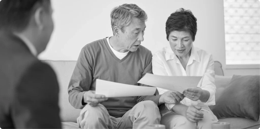 Older couple reviewing financial documents with an advisor