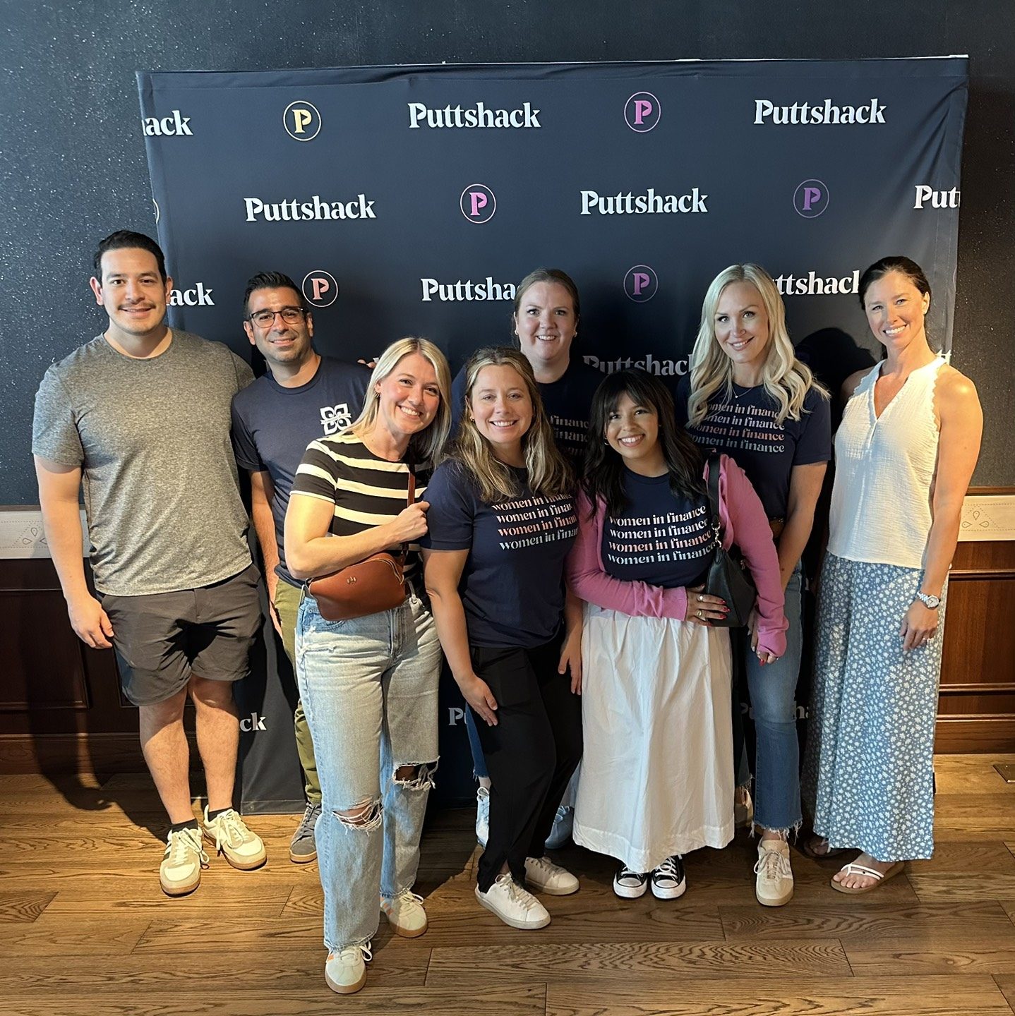 Nicole Madosik poses with Mission Wealth colleagues during a team outing at Puttshack.