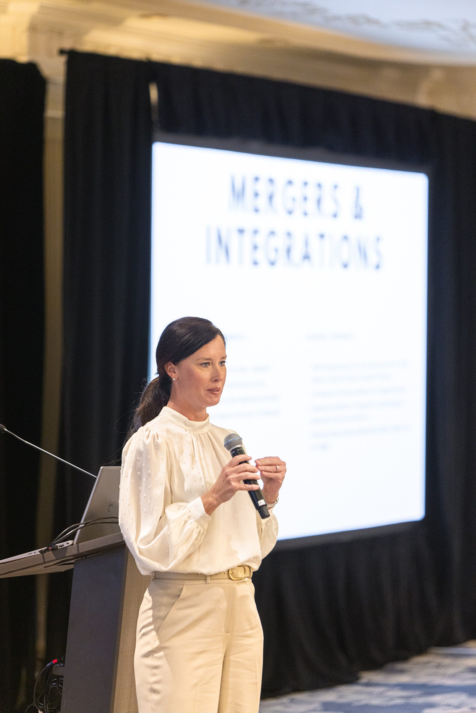 Nicole Madosik presents on mergers and integrations during a Mission Wealth team event.