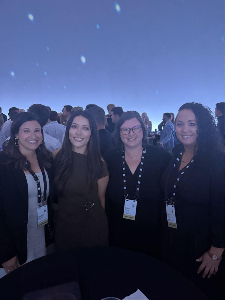 Tina Kunze poses with Mission Wealth colleagues during an evening event.