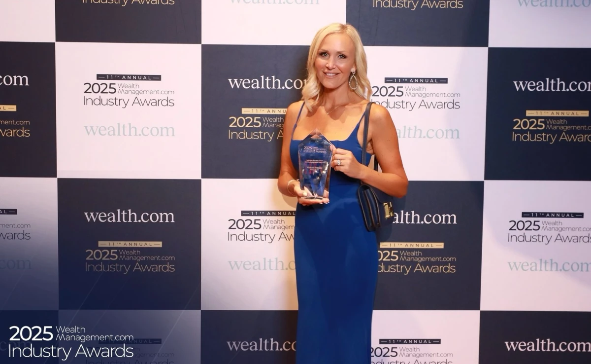 Michelle Winkles holding a 2025 WealthManagement.com Industry Award
