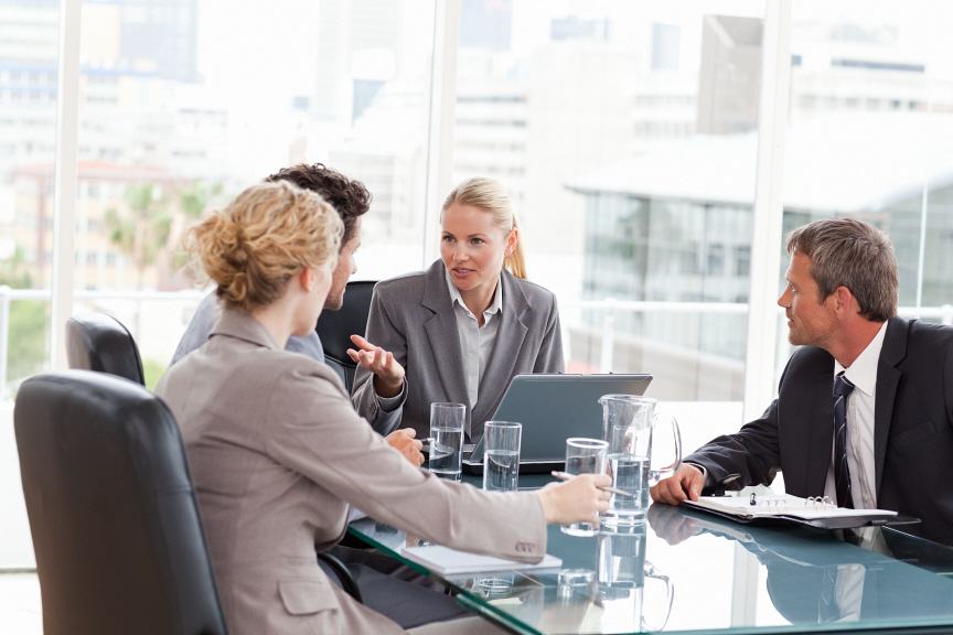 Advisor leading team discussing results.