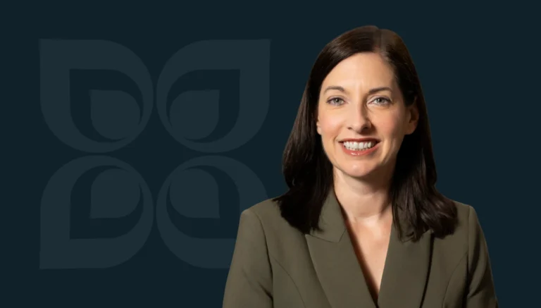 Smiling professional woman in a blazer, set against a dark background with a leaf pattern, representing partnership success.