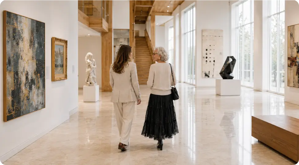 A grandmother and granddaughter stroll through a modern art museum