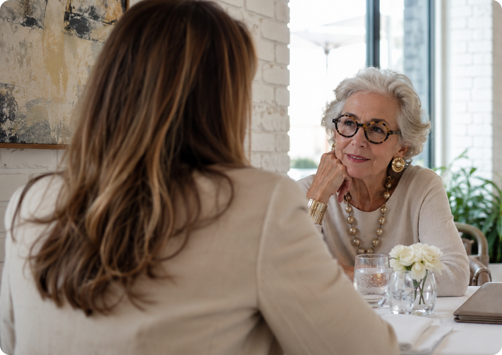A grandmother and granddaughter are eating lunch at a chic bright restaurant