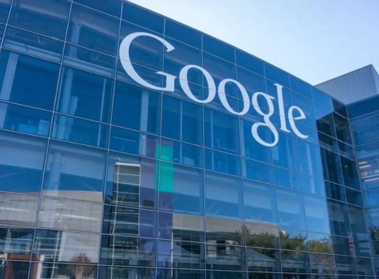 Google's logo prominently displayed on the glass facade of its modern headquarters building.