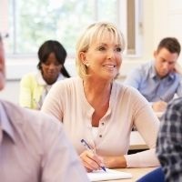 Woman taking notes in class