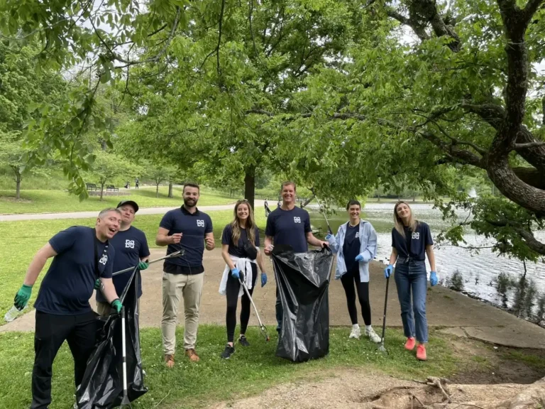 Kieran Osborne collects litter with Mission Wealth colleagues during a park cleanup.
