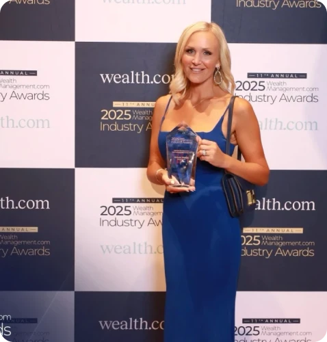 A smiling woman in a blue dress holds an award at the 2025 Wealth Management Industry Awards event.