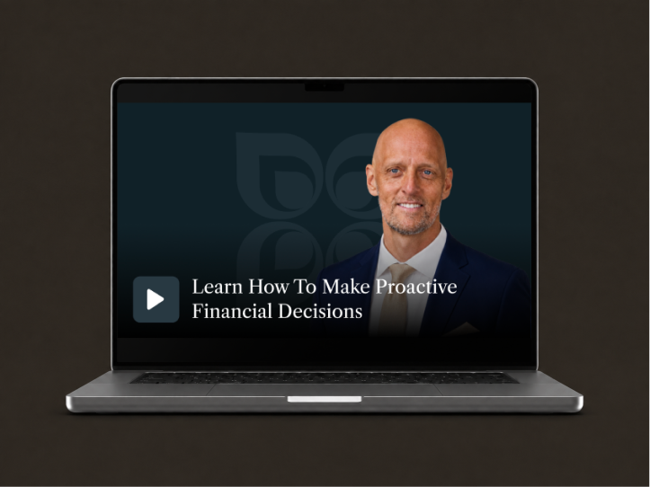 Laptop screen displaying a video titled "Learn How To Make Proactive Financial Decisions" featuring a professional speaker.